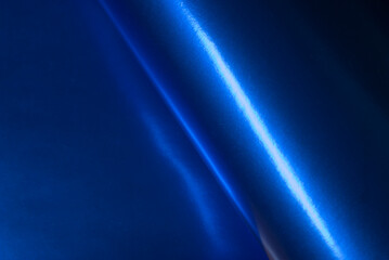 Fototapeta premium Vibrant blue foil reflective curve creating a calm modern studio aesthetic.
