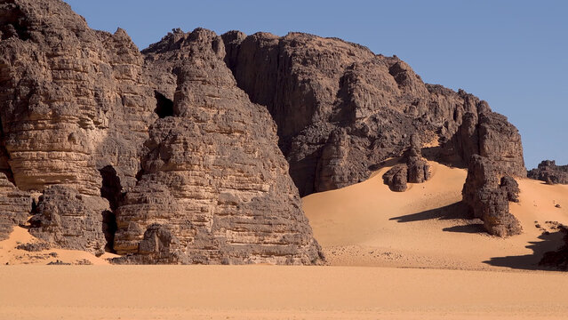 Trip to Sahara desert in Algeria. 
Beautiful african travel photo. Landscape with sandstone 
mountains, sand, sky, nature. Summer vacation in arab country.