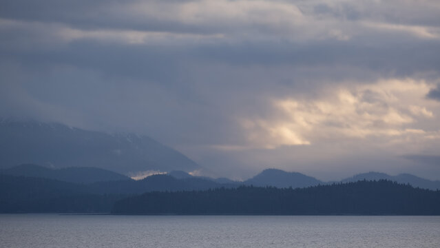 Breathtaking Alaska mountain glacier range view seen from outdoor deck of cruise ship liner sailing the Inside Passage transit with spectacular landscape wilderness scenery