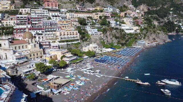 Aerial static hover shot of Positano beach and turquoise sea 4K