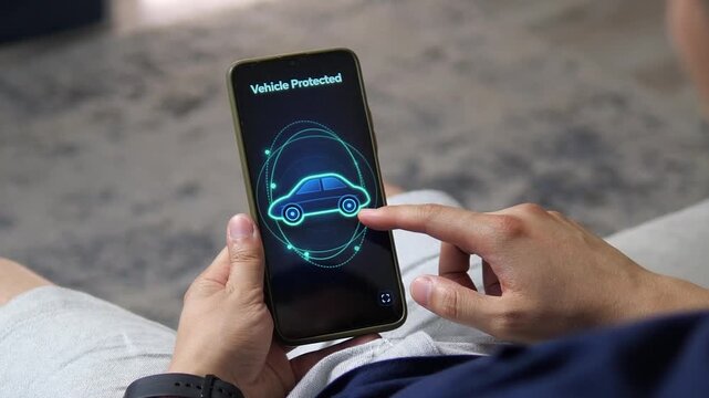 Person checks a smartphone showing vehicle protection status, highlighting connected car security, anti-theft technology and growing concern over automotive cybersecurity.