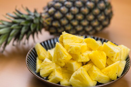 Fresh pineapple chunks in plate with fruit
