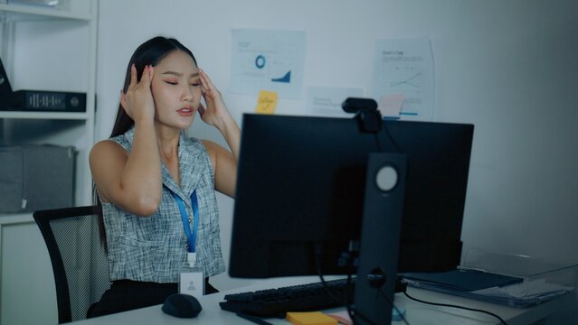 headache office stock scene with pain, syndrome, and overtime. This headache office setting presents worker, computer, while headache and office create a clear commercial visual context.