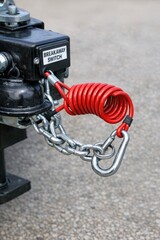 Fototapeta premium A close-up view of a tow chain attached to a tow truck, ideal for uses such as automotive photography or repair documentation