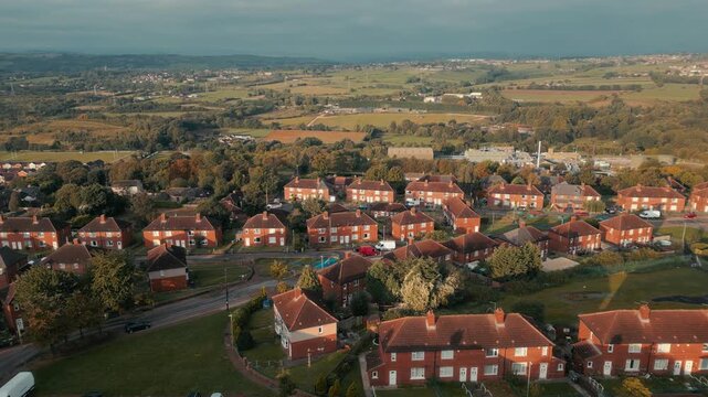 Sunset bathes red-tiled homes in golden glow
