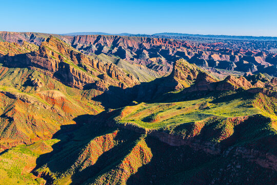 Panoramic view of colorful Tianshan Baili Danxia landform with dramatic rock layers in Xinjiang, China.
