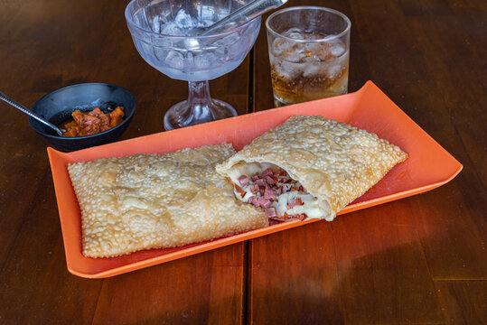Brazilian pastry pastel with filling and drink