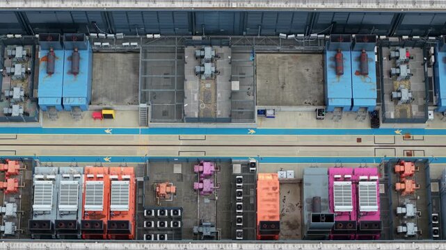 Aerial view of the NTT 3 Data Center featuring colorful cooling units and industrial infrastructure on the rooftop in Hemel Hempstead, England, United Kingdom.