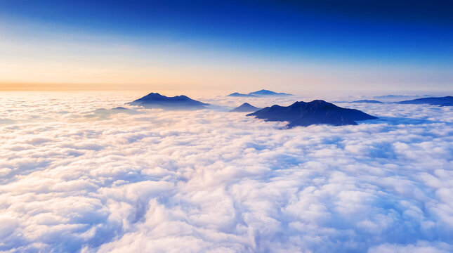 Mountain Peaks Rising Above a Sea of Clouds at Sunrise