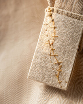 Digital product passport concept with close up of fabric label and stitching on beige textile background