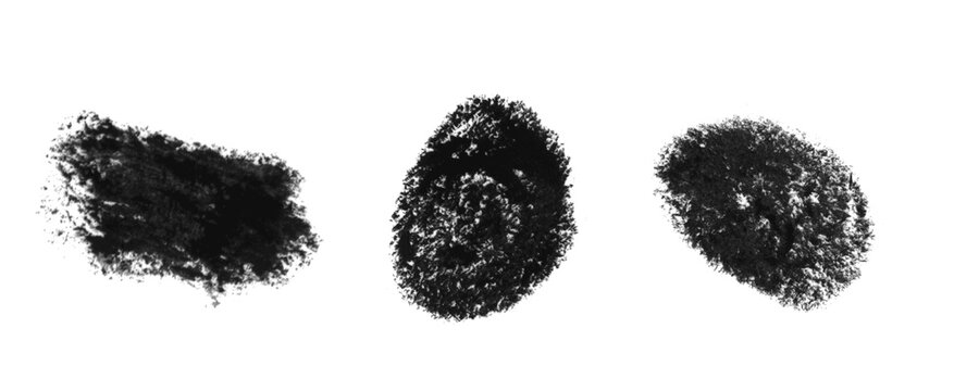 Three black charcoal pencil scribble marks and rough textured spots on a paper surface Background