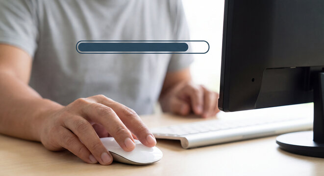 Close up of user holding white computer mouse on office desk with digital progress loading bar graphic superimposed above computer monitor