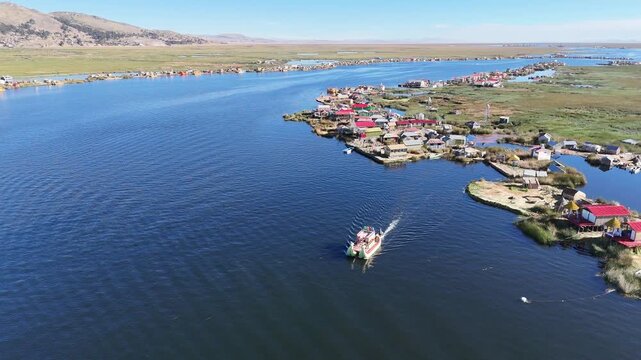 Overhead drone footage capturing the intricate layout of the Uros floating islands made of totora reeds in Peru.
