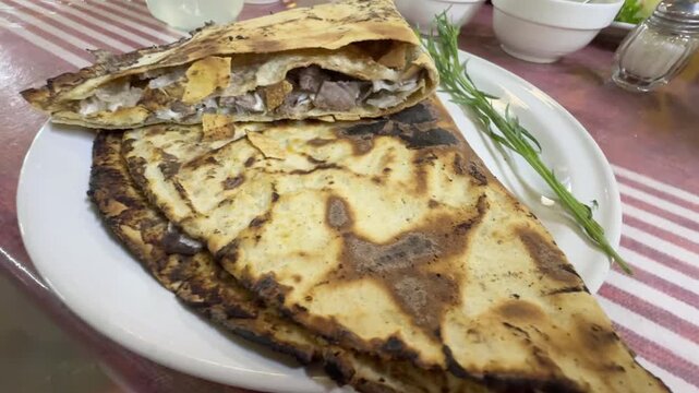 Traditional Oaxacan Tlayuda Folded Crispy Corn Tortilla Stuffed with Meat and Quesillo