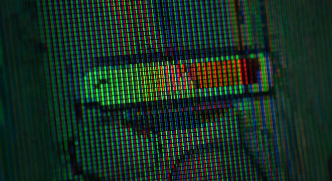 Macro view of digital screen matrix showing individual red green and blue subpixels forming a glowing user interface graphic