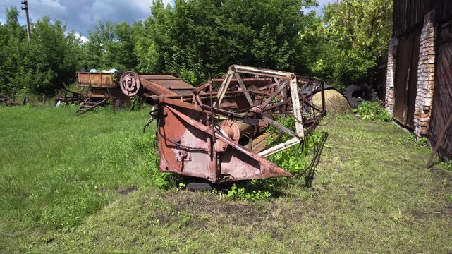 old red combine harvester repair threshing machine replacement of whips on the drum welding work to improve the efficiency of the unit