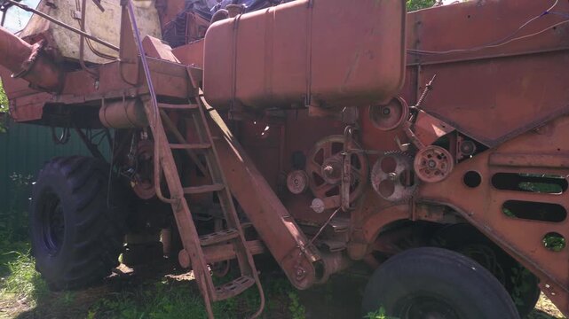 old red combine harvester repair threshing machine replacement of whips on the drum welding work to improve the efficiency of the unit