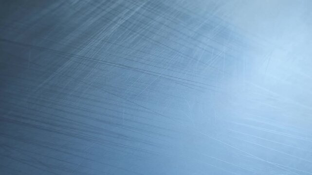 Blue Scratched Metal Surface with Diagonal Lines and Soft Reflective Light