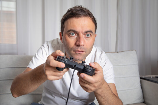 Man playing video game using game controller.