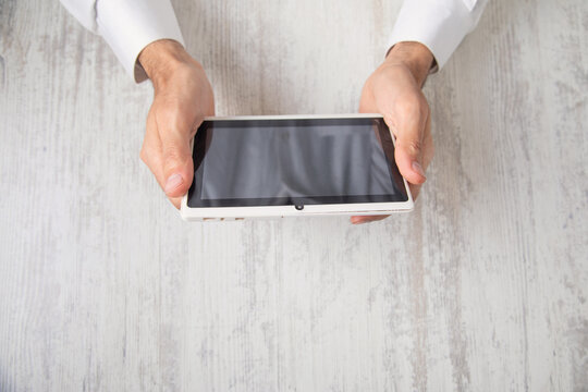 Caucasian businessman using tablet in office.