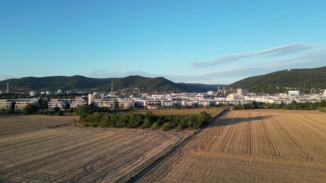 Aerial Pan Rising over Heidelberg Bahnstadt with Kirchheim Fields in Foreground, Germany