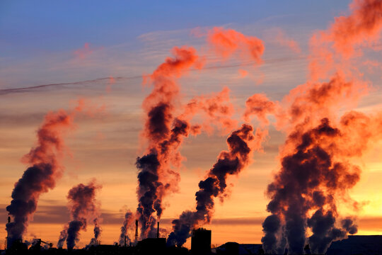 Factory Pumping Pollution Into Air Smokestack Environment Emissions at Sunset