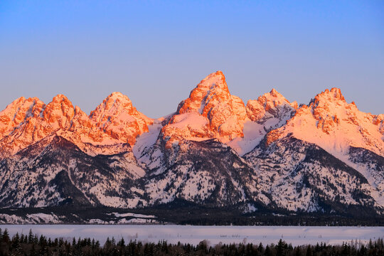 Sunrise on Teton Mountain Range in Wyoming Alpen Glow Orange and Pink on Rugged Mountains