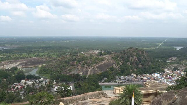 Aerial View of Hilltop Village with Fort Ruins in Karnataka During Monsoon Season, Greenery, Rocky Hills, Cloudy Sky, Serene Landscape, Historical Site, Indian Architecture, Palm Trees, Village Life