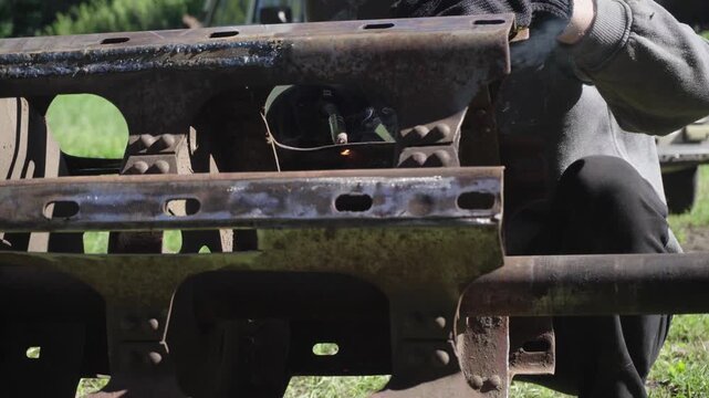 old red combine harvester repair threshing machine replacement of whips on the drum welding work to improve the efficiency of the unit