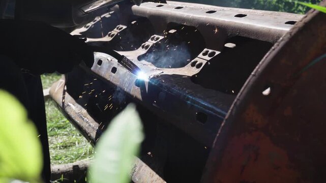 old red combine harvester repair threshing machine replacement of whips on the drum welding work to improve the efficiency of the unit