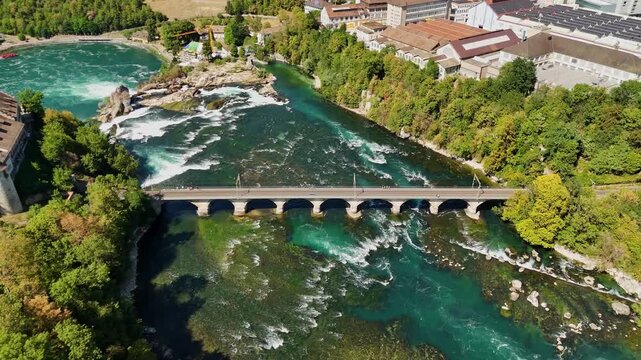 Aerial view of the Rhine Falls and the historic railway bridge spanning the river in Schaffhausen, Schaffhausen, Switzerland.
