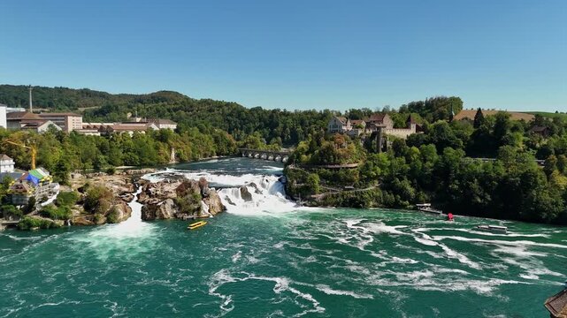 Aerial view of the powerful Rhine Falls waterfall with lush greenery and historic Laufen Castle in Schaffhausen, Schaffhausen, Switzerland.