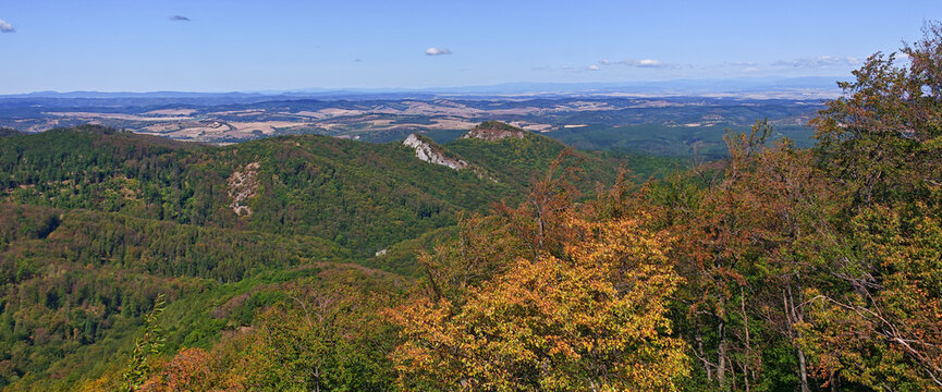 Wide panoramic landscape from Kapu-berc overlooking the forested Verebce Ridge and Dedes Castle hills, with early autumn foliage in the Bukk Mountains, Hungary.