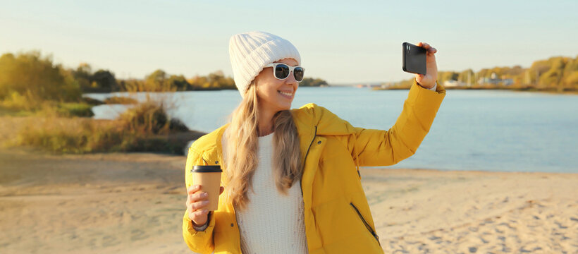 Travel, traveler woman taking selfie with phone on beach, girl using smartphone on coast