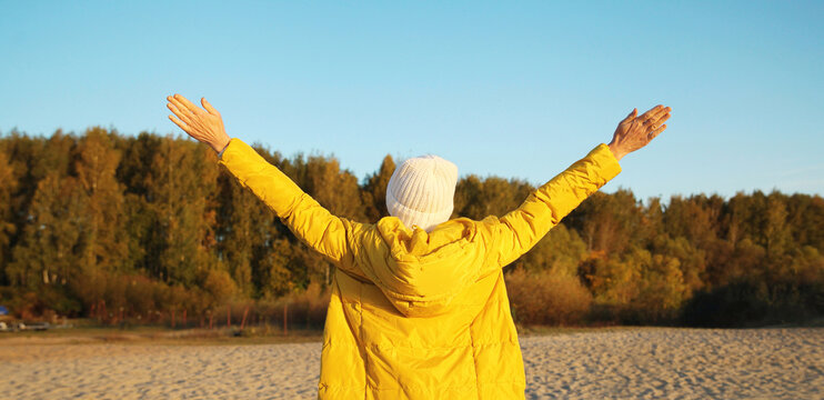 Happy woman on beach, enjoying amazing landscape, warm weather standing on sea coast