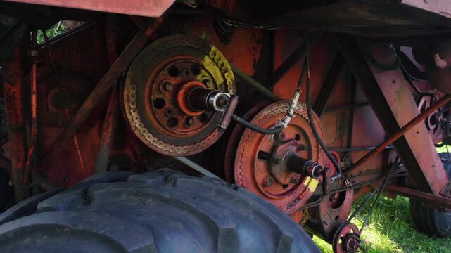 old red combine harvester repair threshing machine replacement of whips on the drum welding work to improve the efficiency of the unit