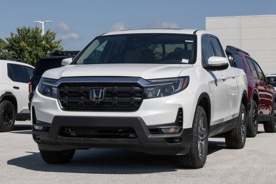 Honda Ridgeline RTL Midsize Pickup Truck at a dealership. Honda offers the Ridgeline with a 3.5L VTEC V6 engine. MY:2026