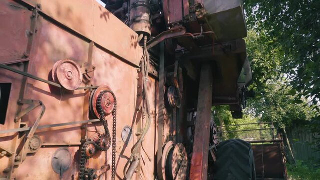 old red combine harvester repair threshing machine replacement of whips on the drum welding work to improve the efficiency of the unit