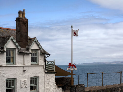 CLOVELLY, DEVON - JULY 27, 2026:  Exterior of The Red Lion Hotel on the Quay with sign