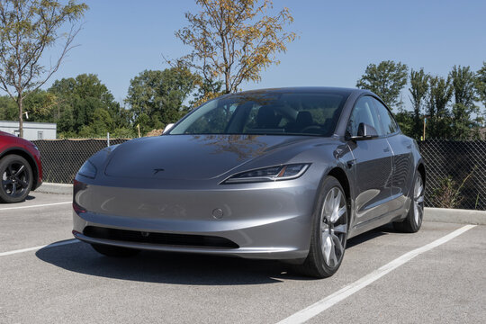 Tesla Model 3 Electric Sport Sedan at a dealership. Tesla offers the Model 3 with up to 321 miles driving range. MY:2026