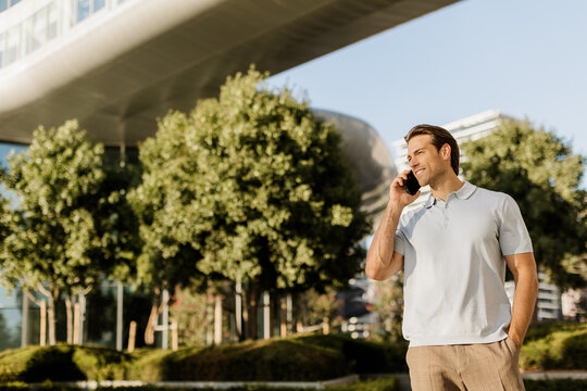 Confident man enjoying a sunny afternoon while talking on his phone