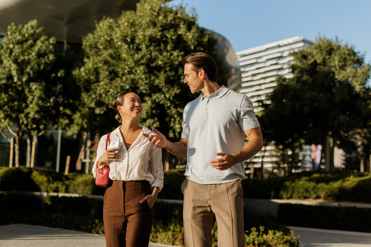 Joyful moments shared between a Korean woman and Caucasian man under the sun