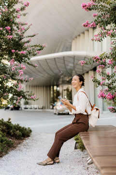 Korean woman enjoys warm afternoon surrounded by blooming flowers