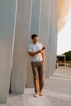 Man enjoying a moment while using his smartphone in an urban setting