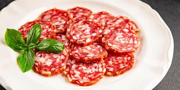 Sausage slices salami cured sausages meat food preparation dish tasty snack fresh and delicious gourmet rustic food background on the table&nbsp; rustic food top view copy space
