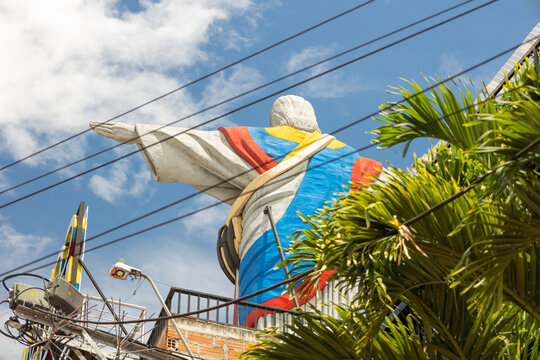 Medell&iacute;n, Antioquia, Colombia - June 29, 2026 - Christ the Redeemer monument with the Colombian flag in San Javier, Comuna 13, Medell&iacute;n, photographed from a low-angle perspective
