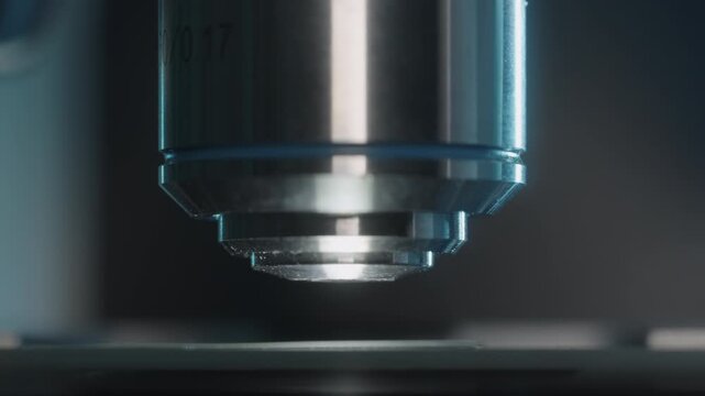 Extreme close-up of microscope objective lens revolving in laboratory