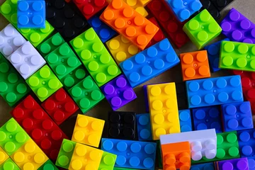 Fotobehang Lego Colorful Plastic Building Blocks Background and Toy Bricks Heap,Top view of a vibrant collection of colorful plastic building blocks and toy bricks scattered randomly, creating a playful and creative   © banjongseal324