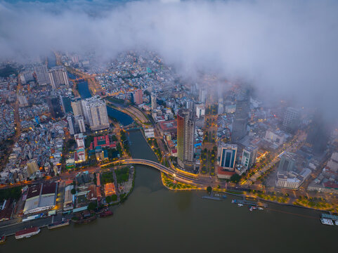 September 15, 2025: Early morning aerial view of Ho Chi Minh City, Vietnam, featuring the Saigon River, Ba Son Bridge, modern skyscrapers, and riverside urban landscape.