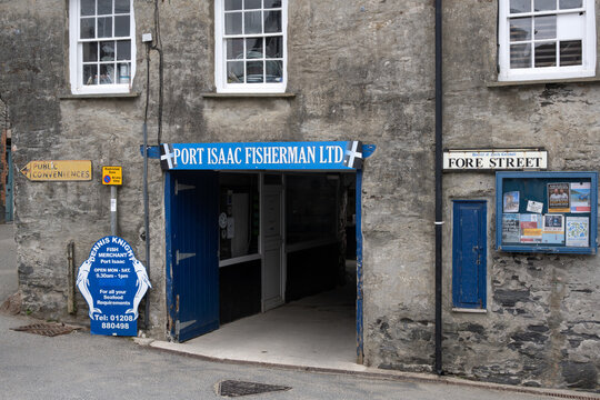 PORT ISAAC, CORNWALL - JULY 27, 2026:  Entrance to Port Isaac Fisherman Company with sign